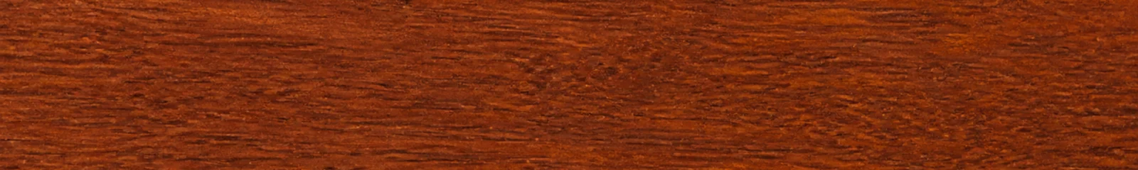 Close-up of deep reddish-brown Merbau timber with natural mineral flecks