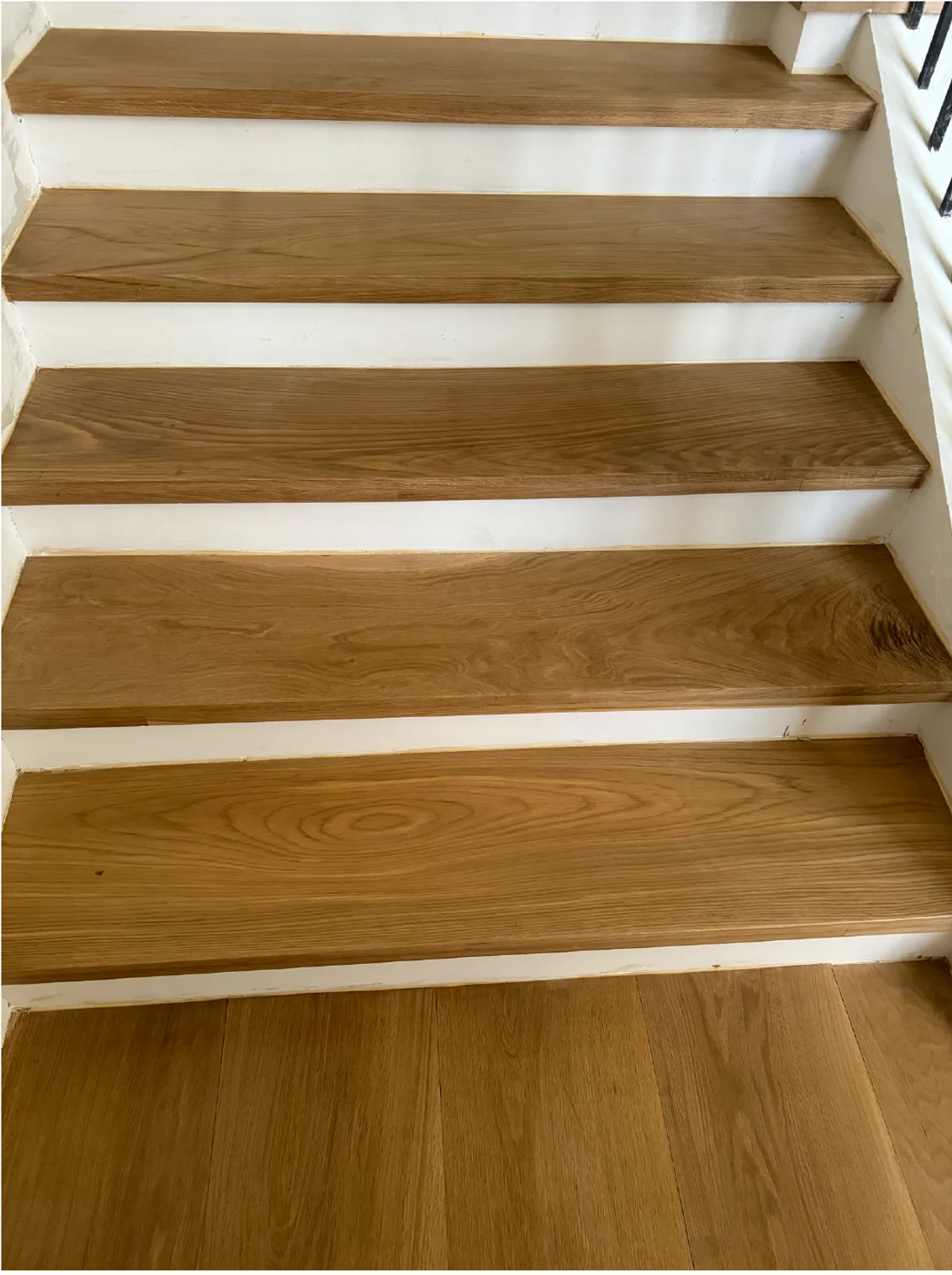 Installed solid oak staircase treads in a residential interior