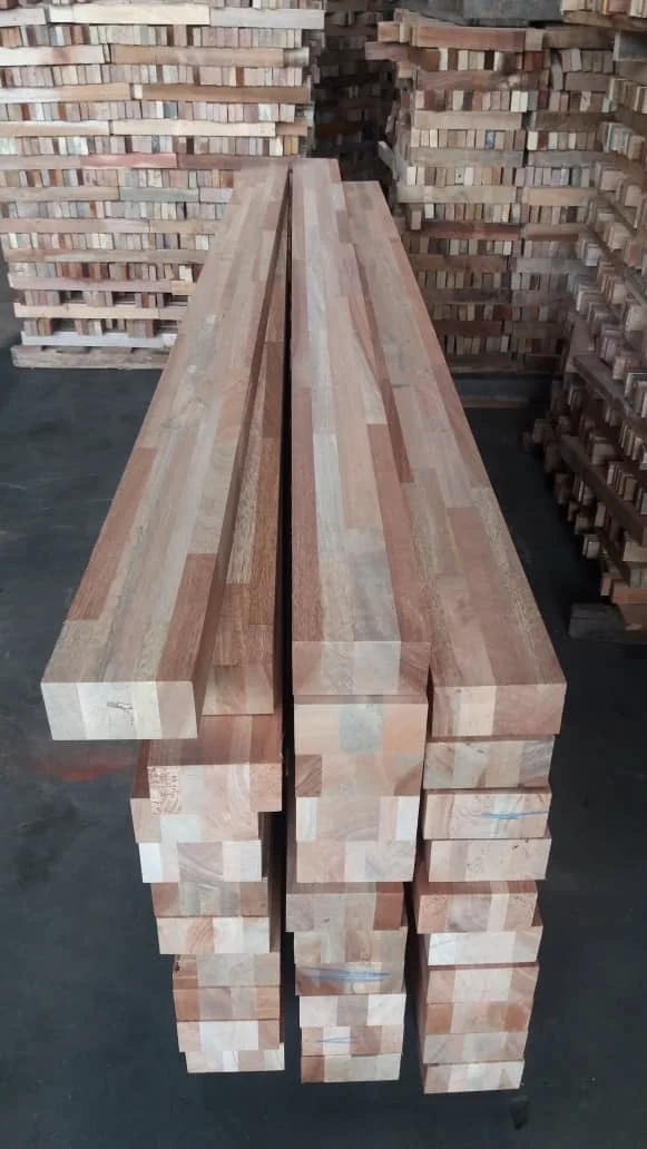 Stacks of glue laminated Meranti and Nyatoh timber sections prepared for window scantlings